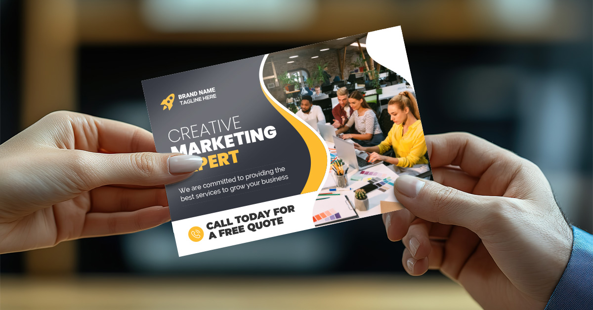 Hands-passing-a-postcard-that-says-creative-marketing-expert-for-Printing